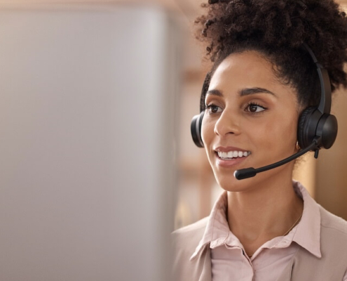 Close-up of woman with headset working in senior living marketing.