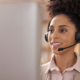 Close-up of woman with headset working in senior living marketing.