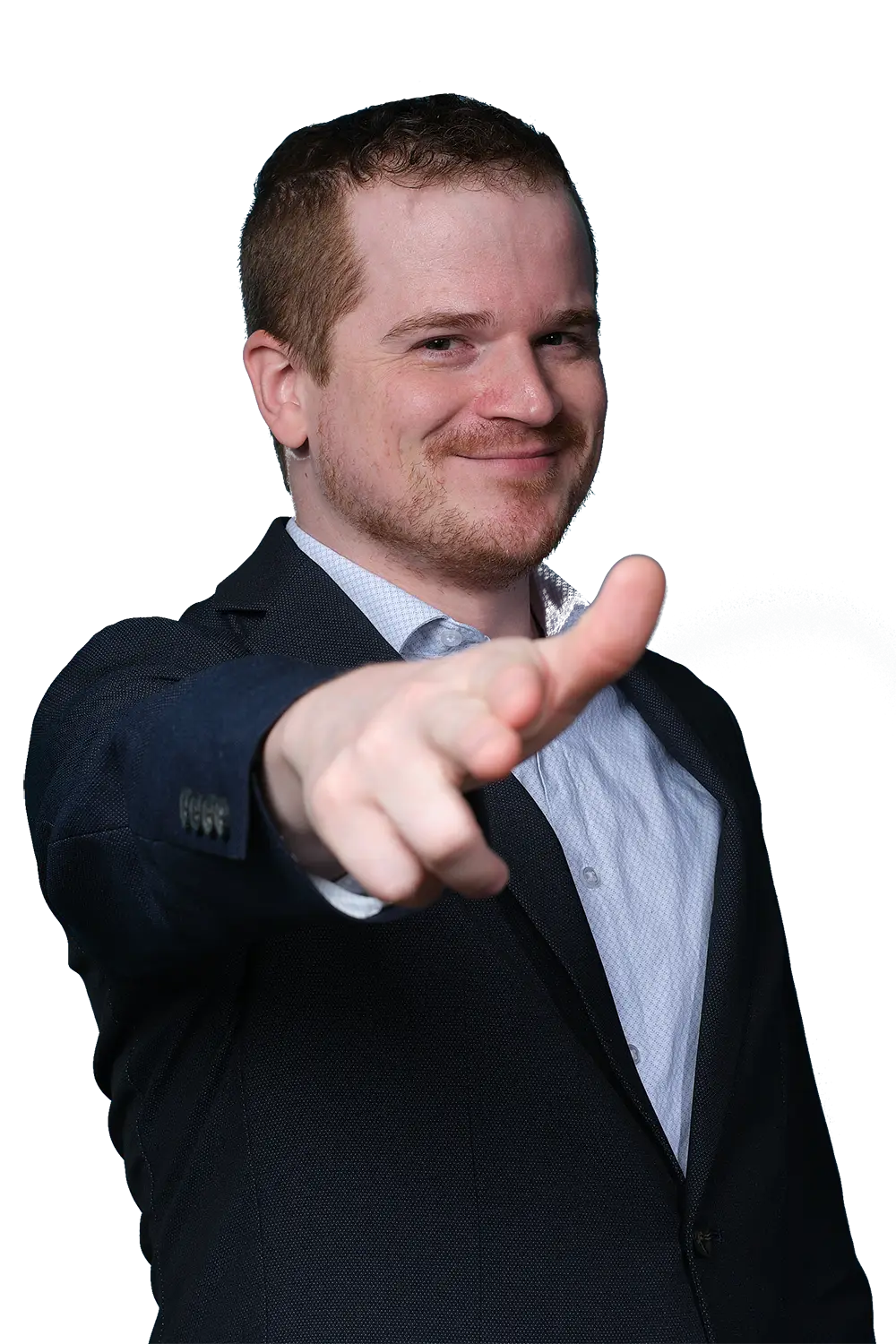A man in a suit smiles and points directly at the camera, standing against a dark blue background.