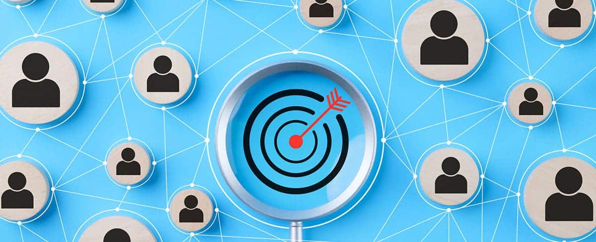 A magnifying glass highlights a bullseye with an arrow in the center, surrounded by networked user icons on a blue background—perfectly capturing the focus and connectivity essential in senior living sales.