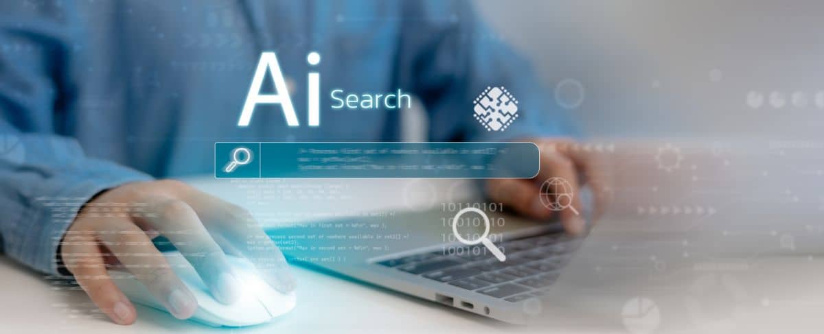 A person uses a computer mouse and laptop with a digital overlay displaying "AI Search" and search icons, highlighting the impact of answer engine optimization on modern queries.