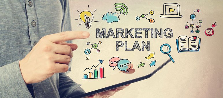 A person holds a tablet with "Marketing Plan" text and vibrant marketing icons, reflecting the creative strategies of a senior living marketing agency.