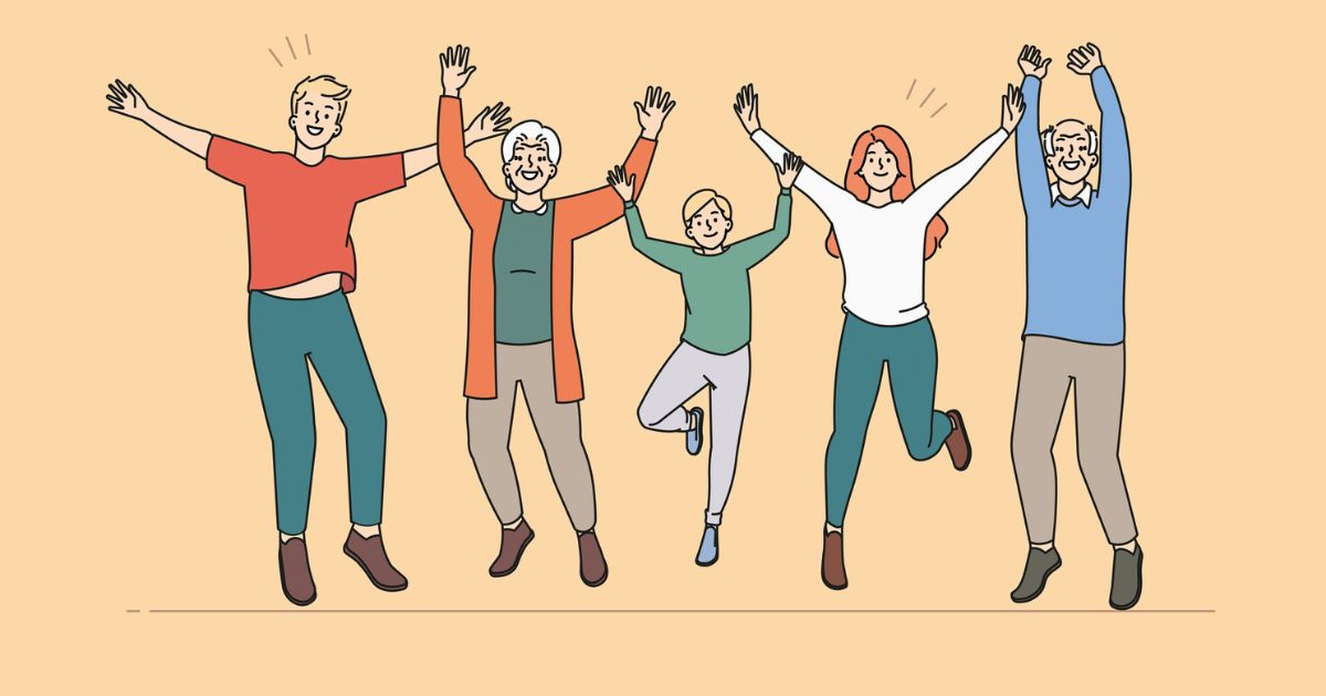 Five people of various ages are jumping and smiling with their arms raised against a beige background, showcasing the joy and energy that marketing to seniors can inspire.