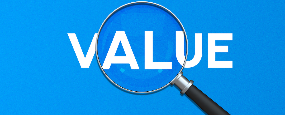 A magnifying glass enlarges part of the word "VALUE" on a bright blue background, symbolizing the focus on marketing to baby boomers.