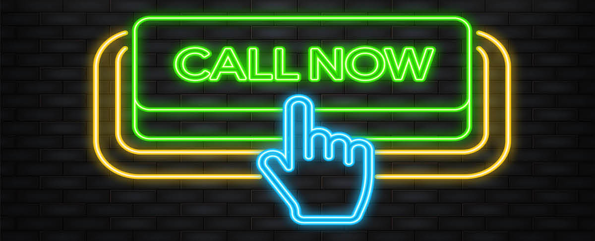 Neon sign showing a hand icon pointing to a green rectangular “CALL NOW” button against a dark brick wall—an eye-catching way to show how to generate leads for senior living facilities.
