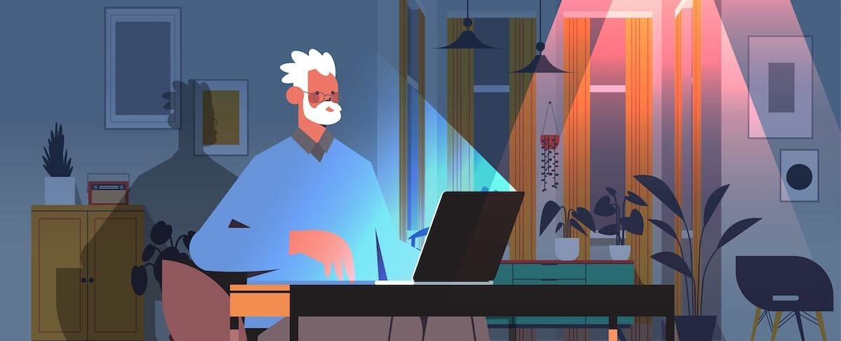 An older man with white hair and glasses sits at a desk using a laptop in a modern, softly lit room with plants and wall decor, appearing to experience email fatigue.