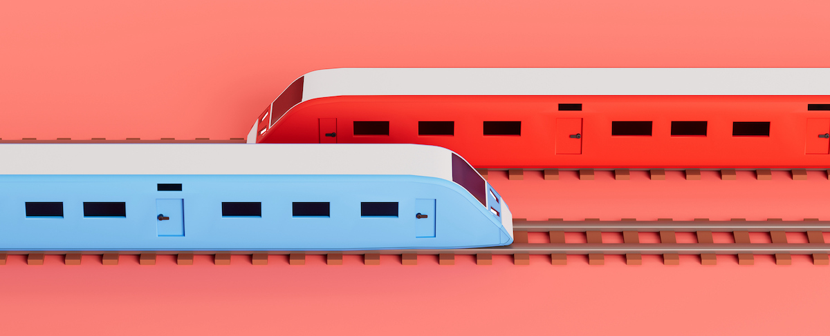 Two modern trains, one blue and one red, travel on parallel tracks against a plain pink background, symbolizing the swift movement of an outbound marketing strategy.