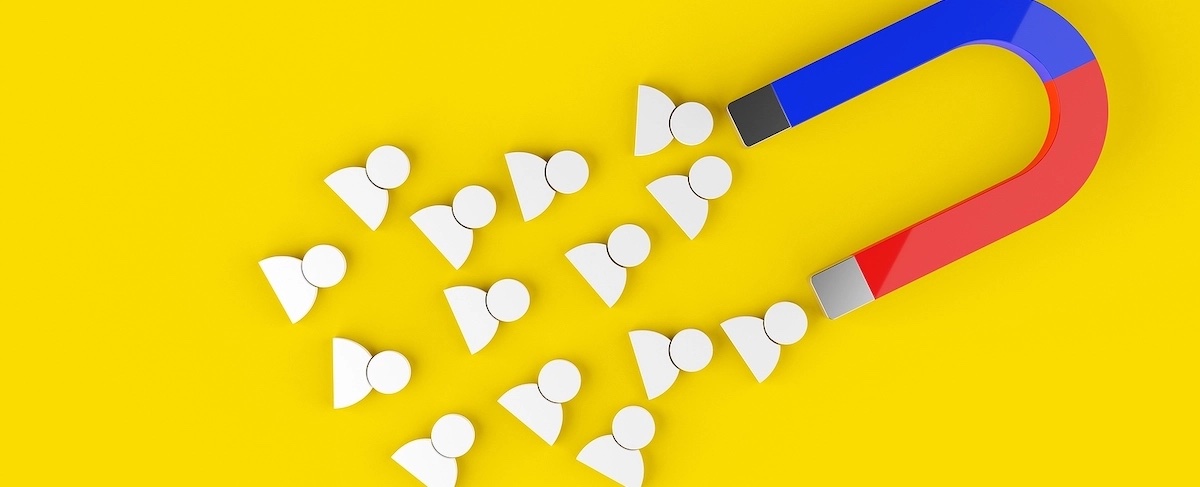 A red and blue horseshoe magnet attracts several white person-shaped icons on a yellow background, symbolizing senior living lead generation.