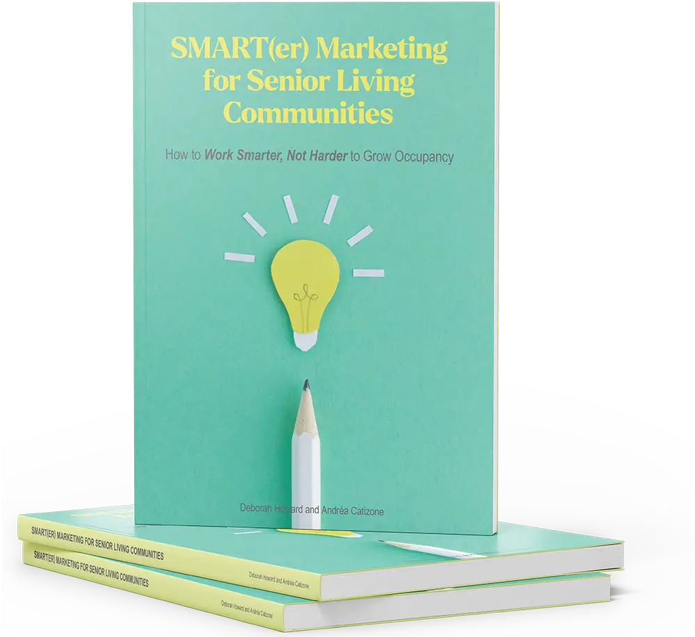 A book titled "SMART(er) Marketing for Senior Living Communities" stands upright on two stacked copies, featuring a cover with a lightbulb and pencil illustration.