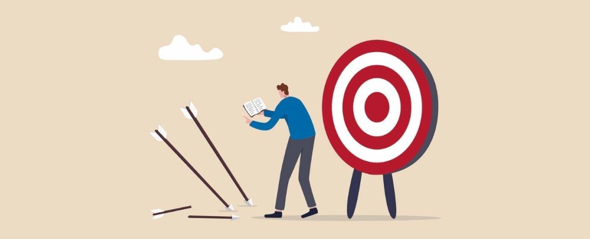 A person reads a book next to a target while several arrows—labeled with “senior living digital marketing”—miss and land on the ground, suggesting challenges in reaching the right audience.